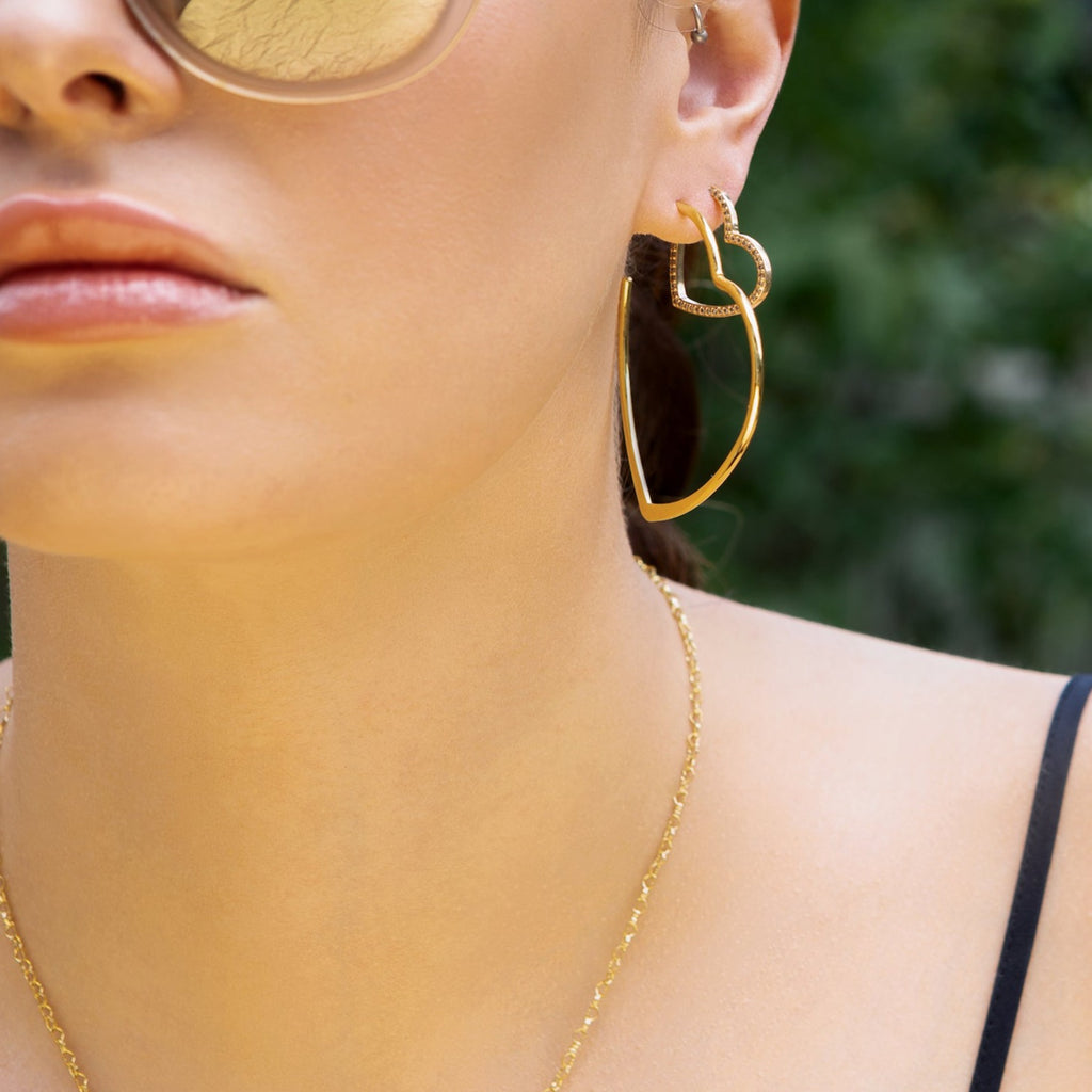 Model wearing Crystal accented heart hoop earrings