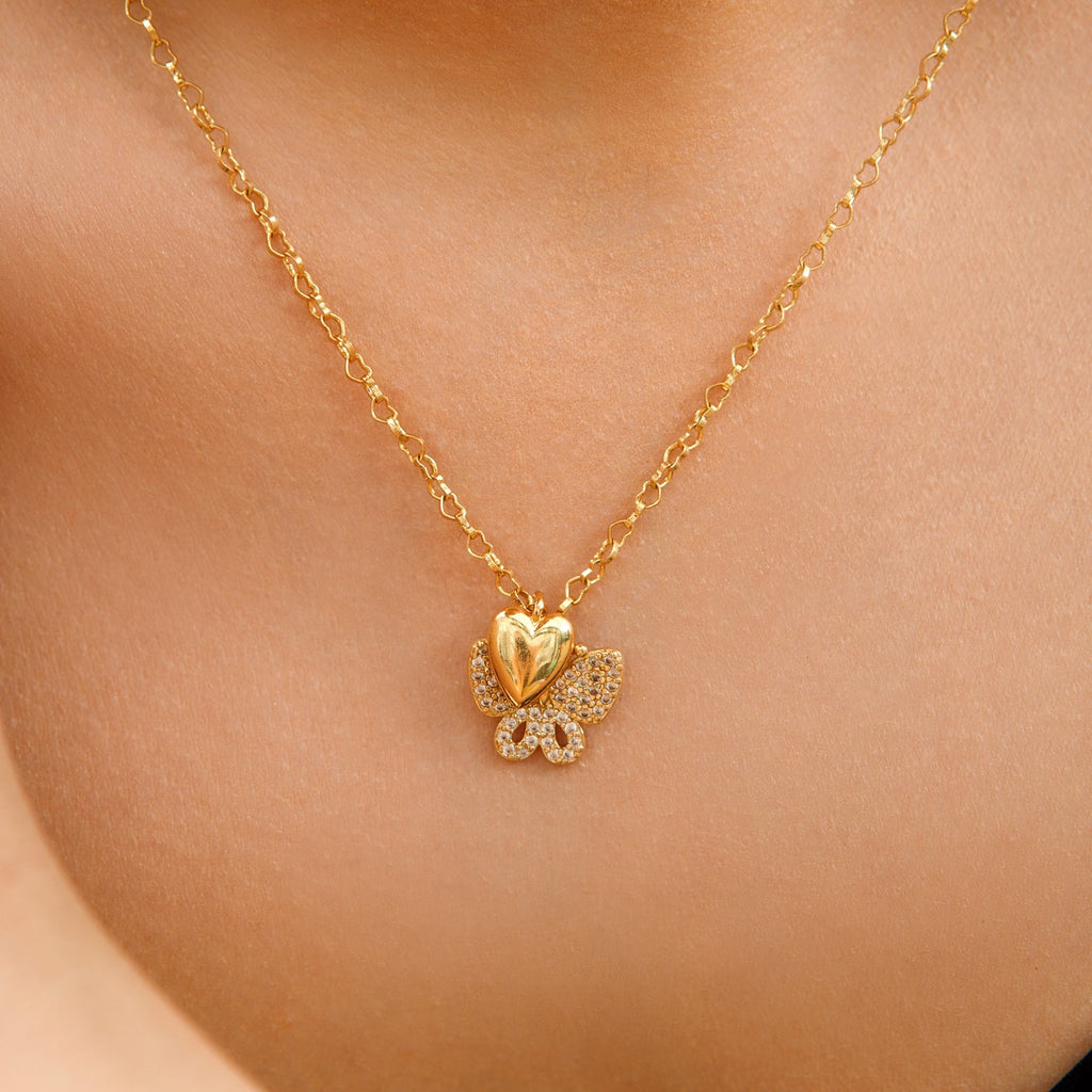 Crystal Butterfly Botanical charm worn with a gold heart charm