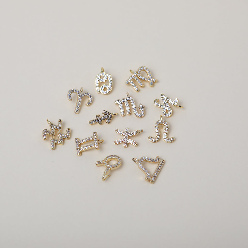 Crystal accented gold zodiac charms
