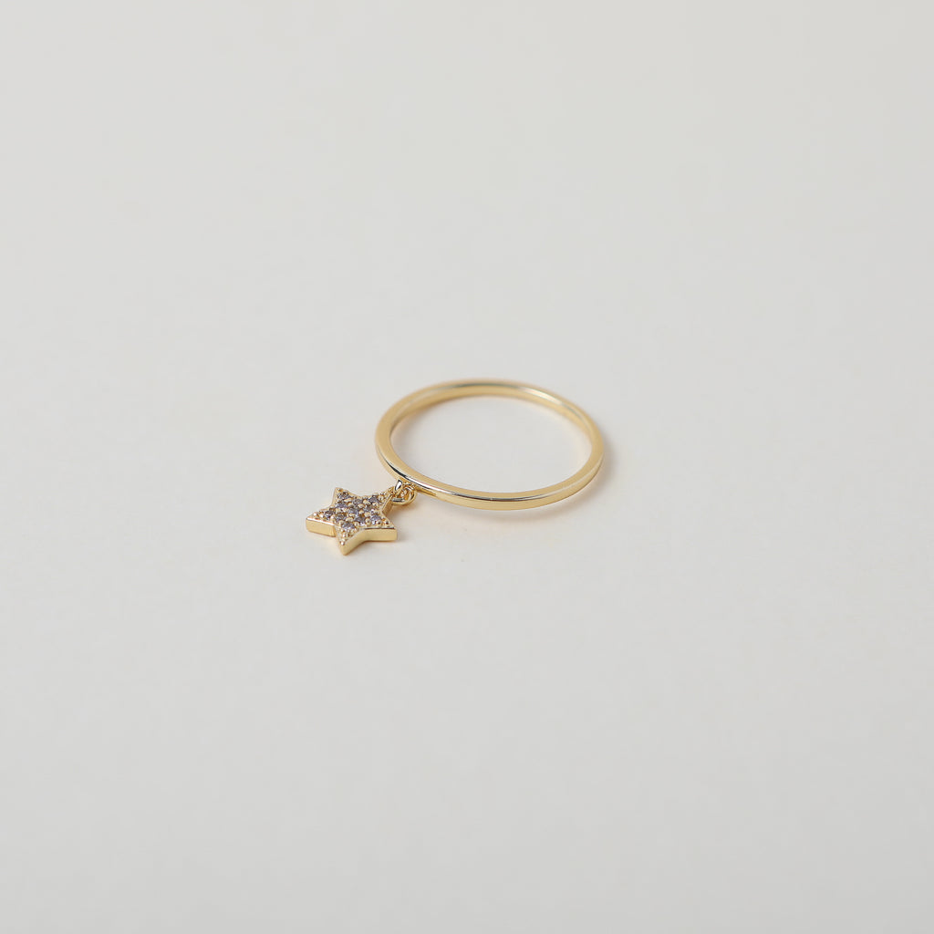 Delicate gold ring with crystal accented star charm