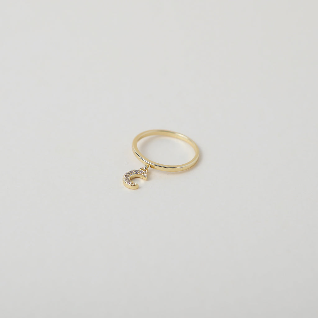 Delicate gold ring with crystal accented crescent moon charm