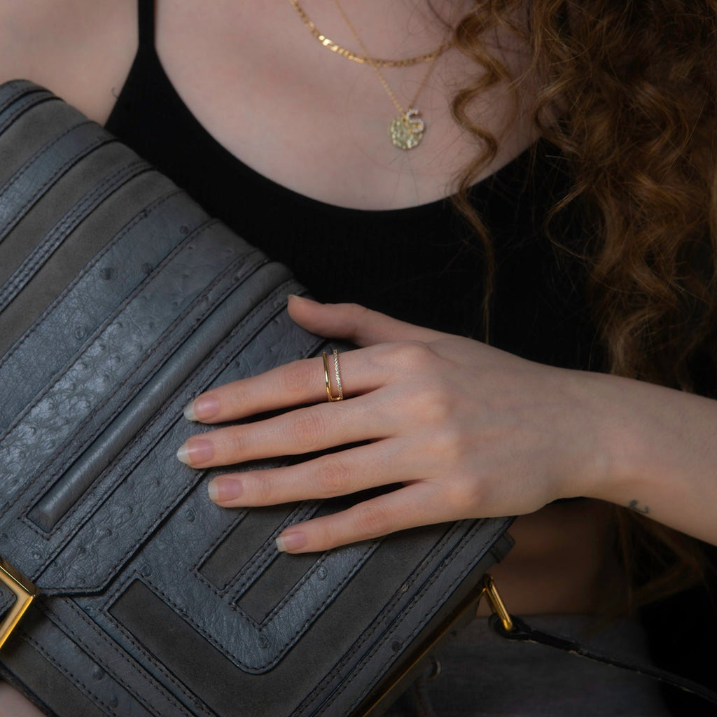 model wearing a square shaped geometric gold and crystal ring