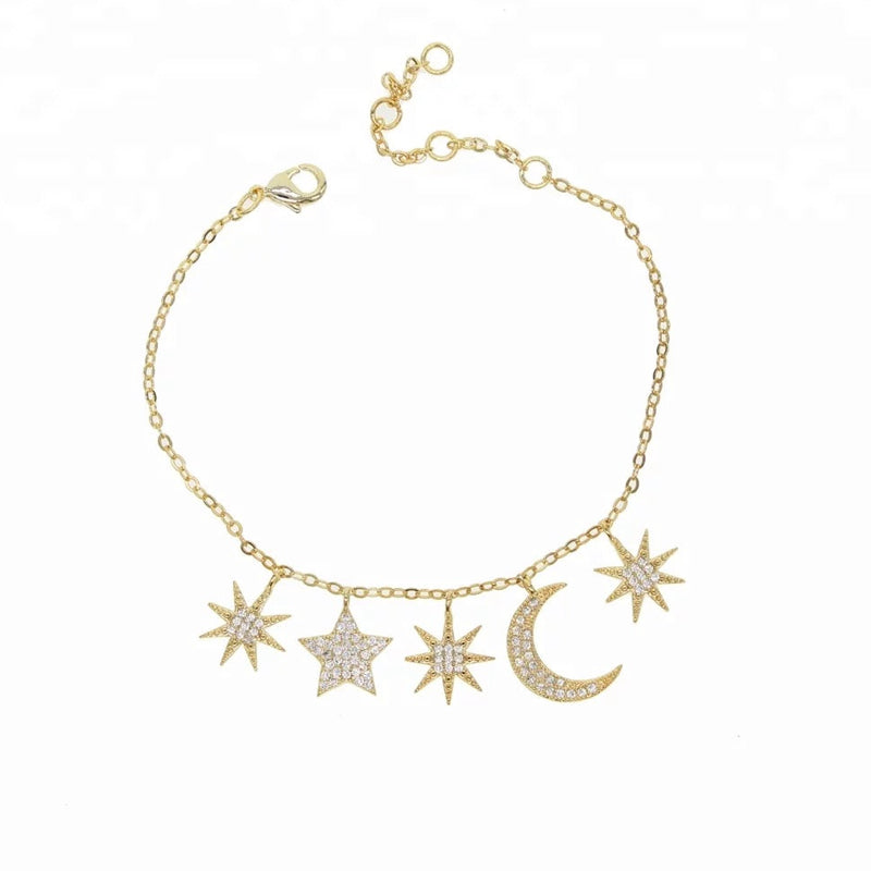 Five crystal embellished moon and star charms on a gold bracelet with lobster clasp closure