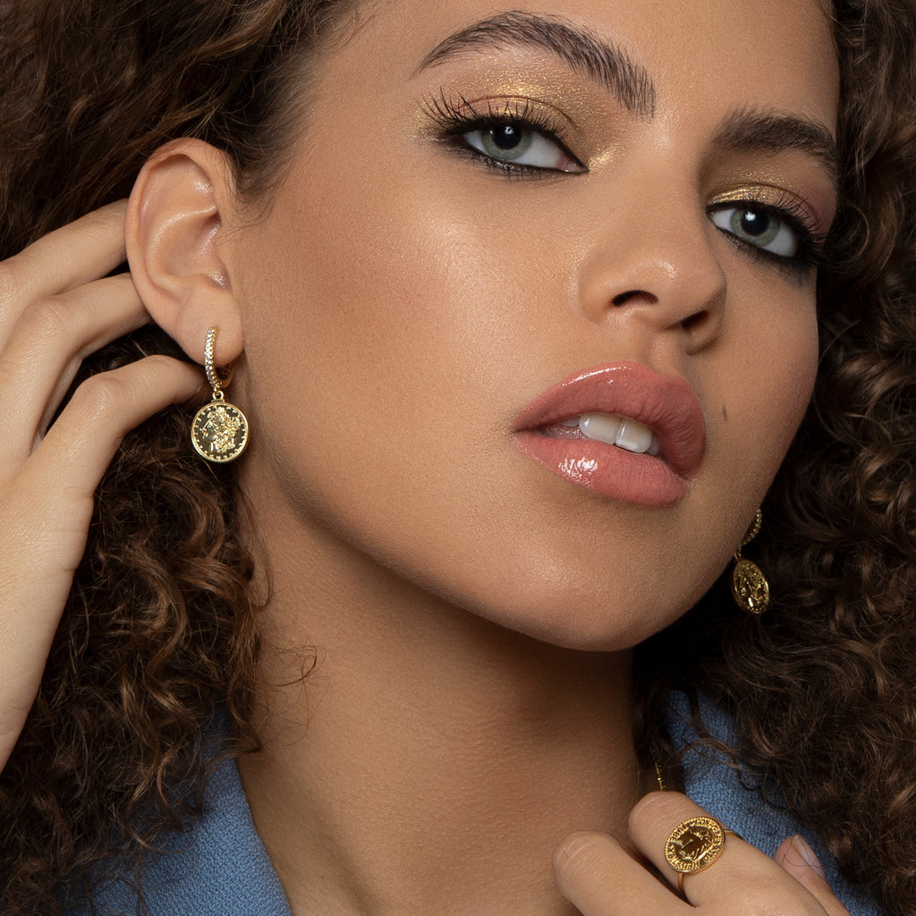 model wears crystal accented Vintage coin drop earrings